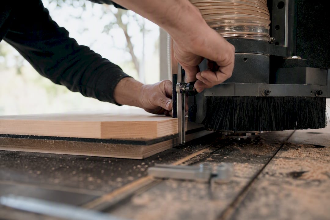 Technician adjusting CNC dust shoe height