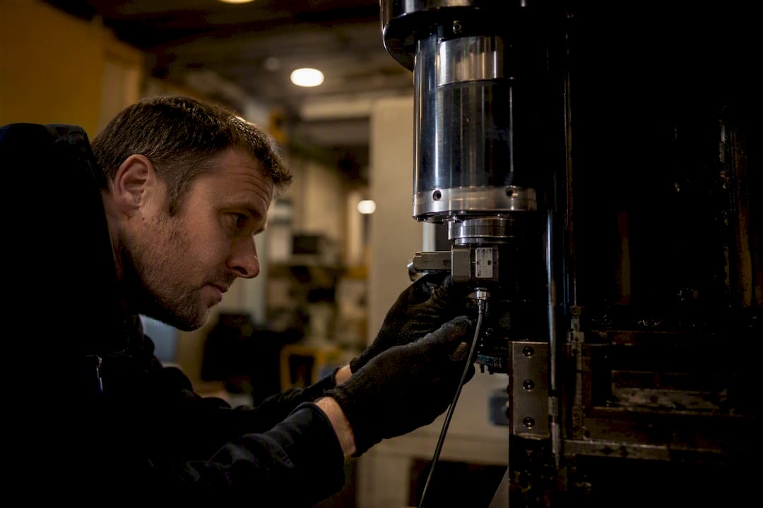 Technician adjusting spindle vibration sensor
