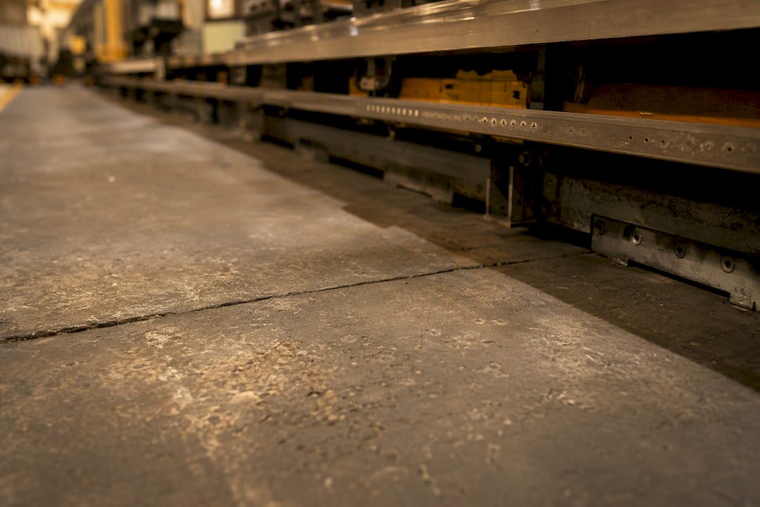 Uneven factory floor under pallet transfer line