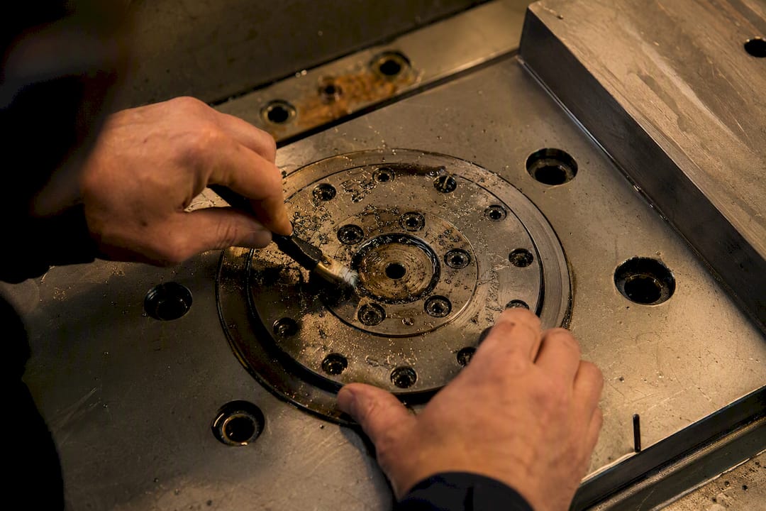 Hands cleaning zero point fixture chips and coolant