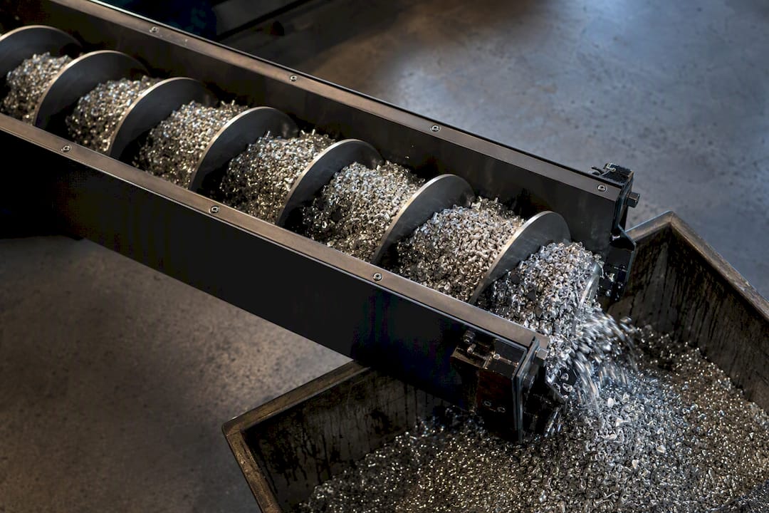 Aluminium chips moving through an auger conveyor