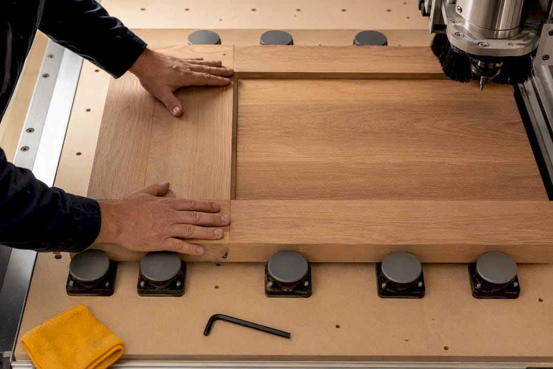 Technician securing a door blank for CNC cutting